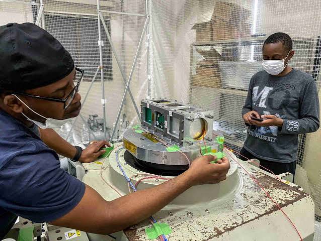 Engineers assembling ZIMSAT satellite hardware in a cleanroom